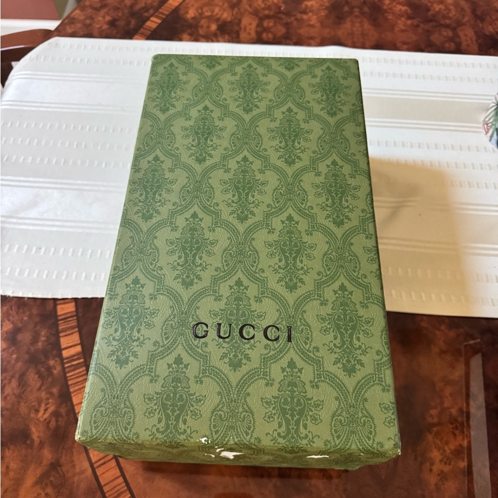 Gucci shoebox in the iconic green color with signature pattern.